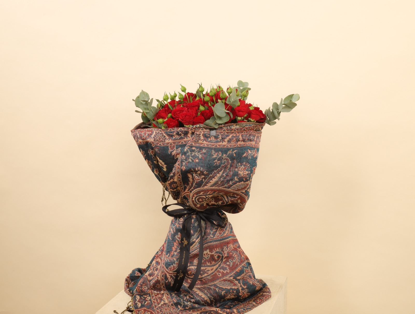 bouquet wrapped in cashmere scarf